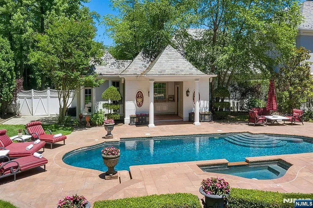 Pool looks crystal with flowers all around. Resort mode activated.