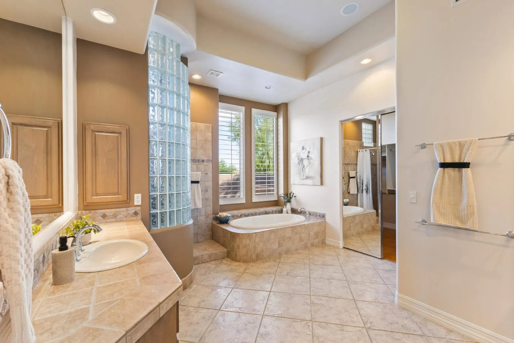 That oval tub by the frosted window feels very spa day.