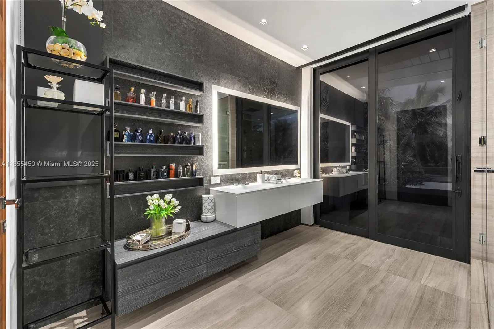 Bathroom one. dark stone walls, warm wood floor. Spa with attitude.