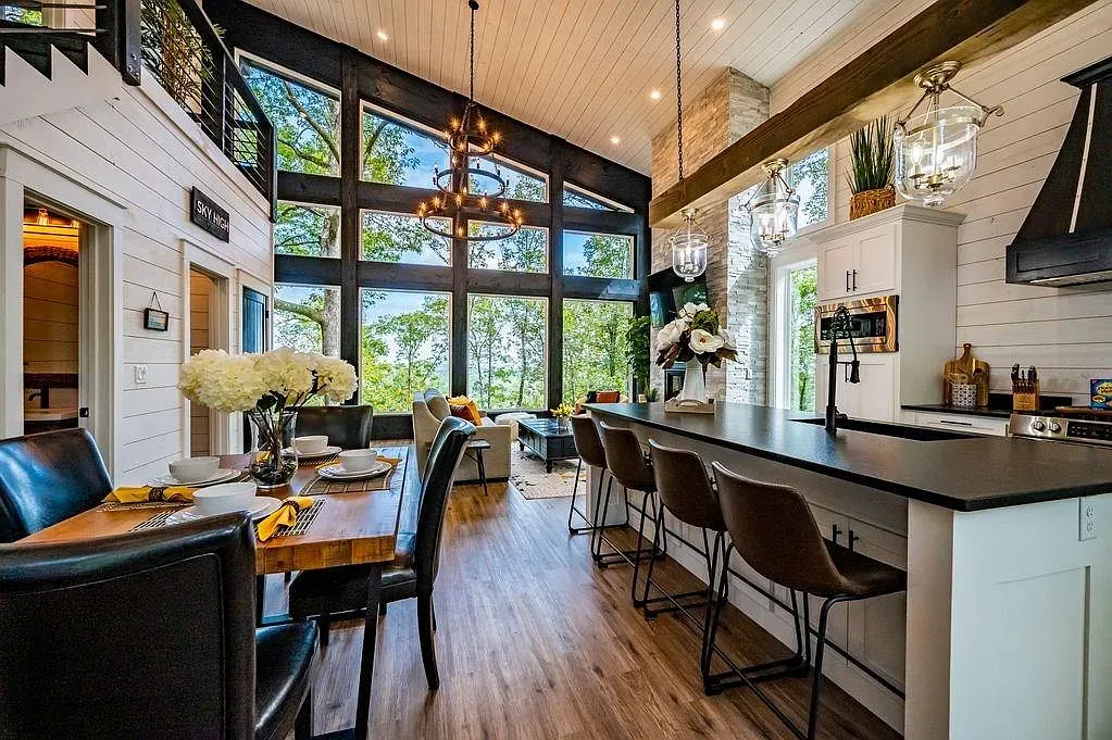 Beams plus white shiplap = classic. Wall of windows brings the trees inside.