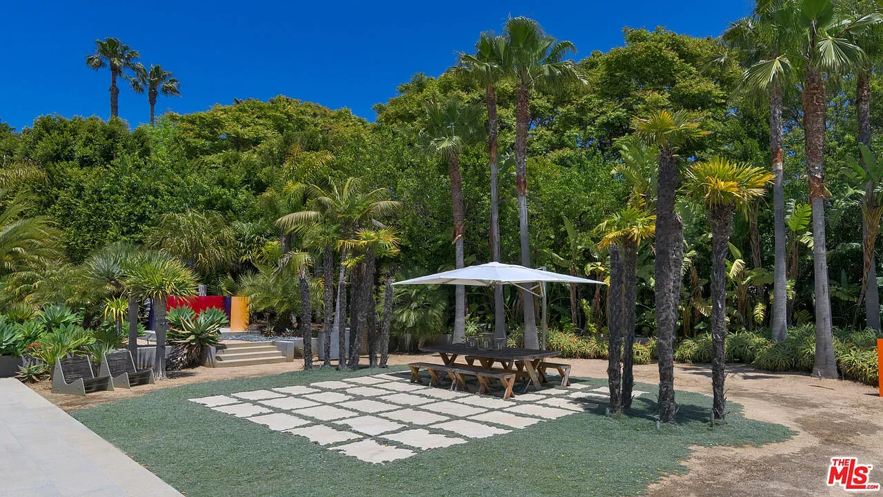 Lush jungle corner with palms and a neat rectangular planter in the middle.