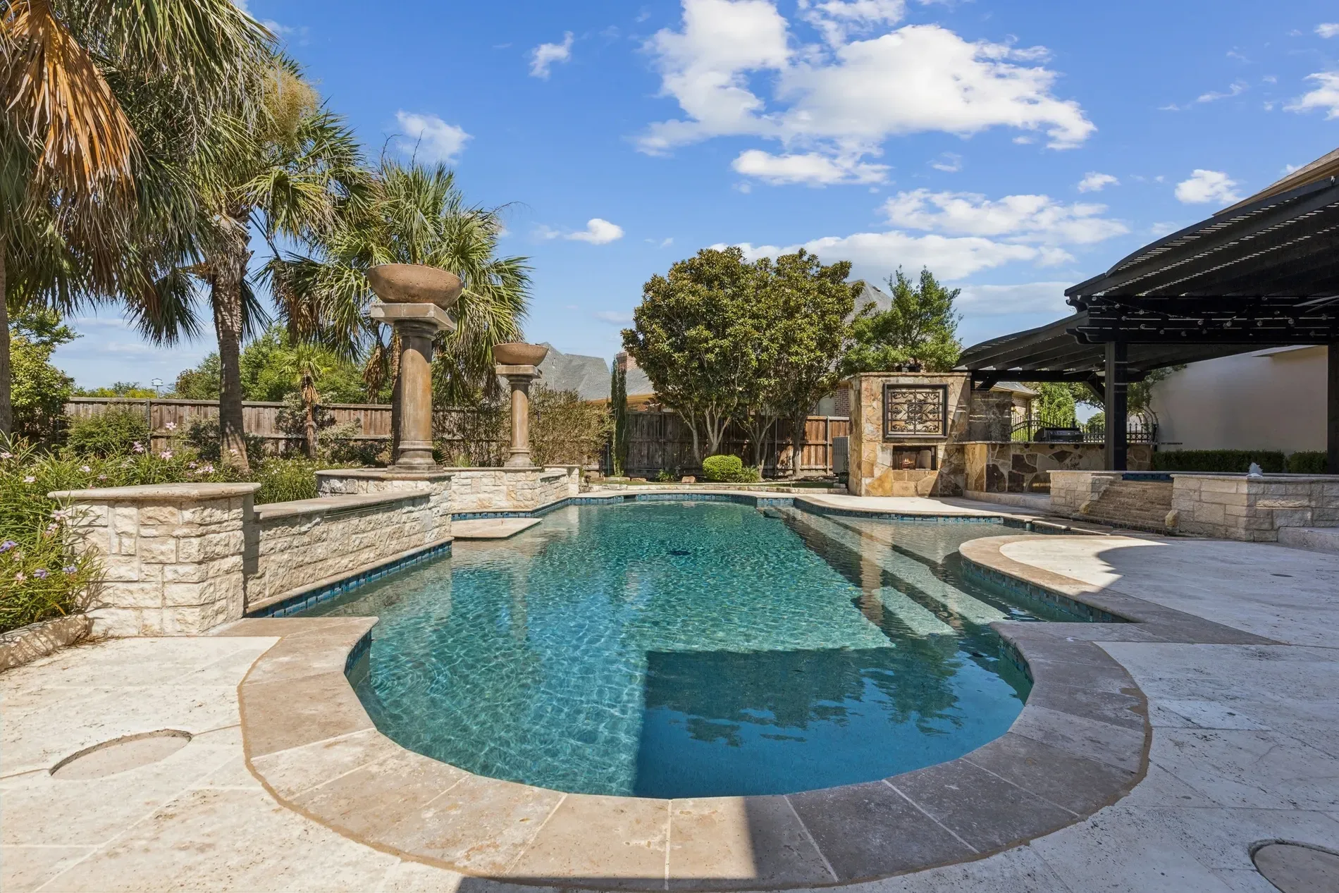 Back outside to the pool — soft curves, blue water, stone edge. Vacation mode.