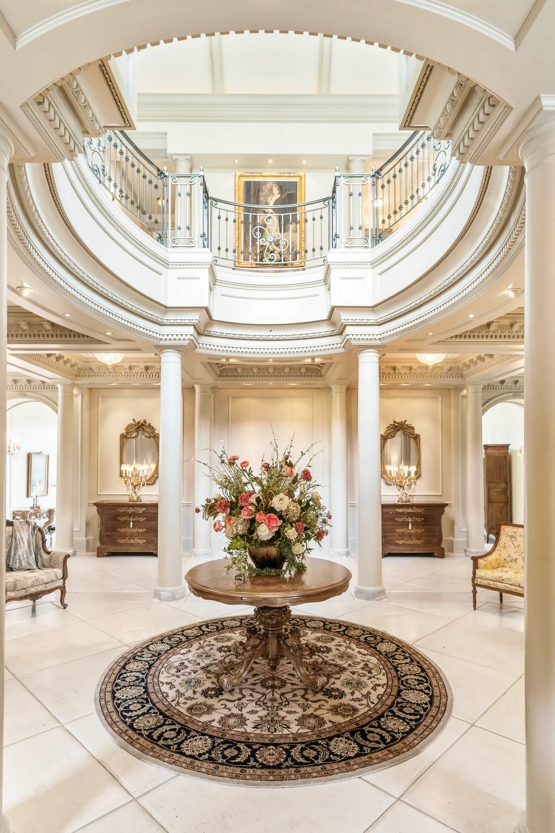 Round foyer with a dome and chandelier stack. Dramatic arrival.