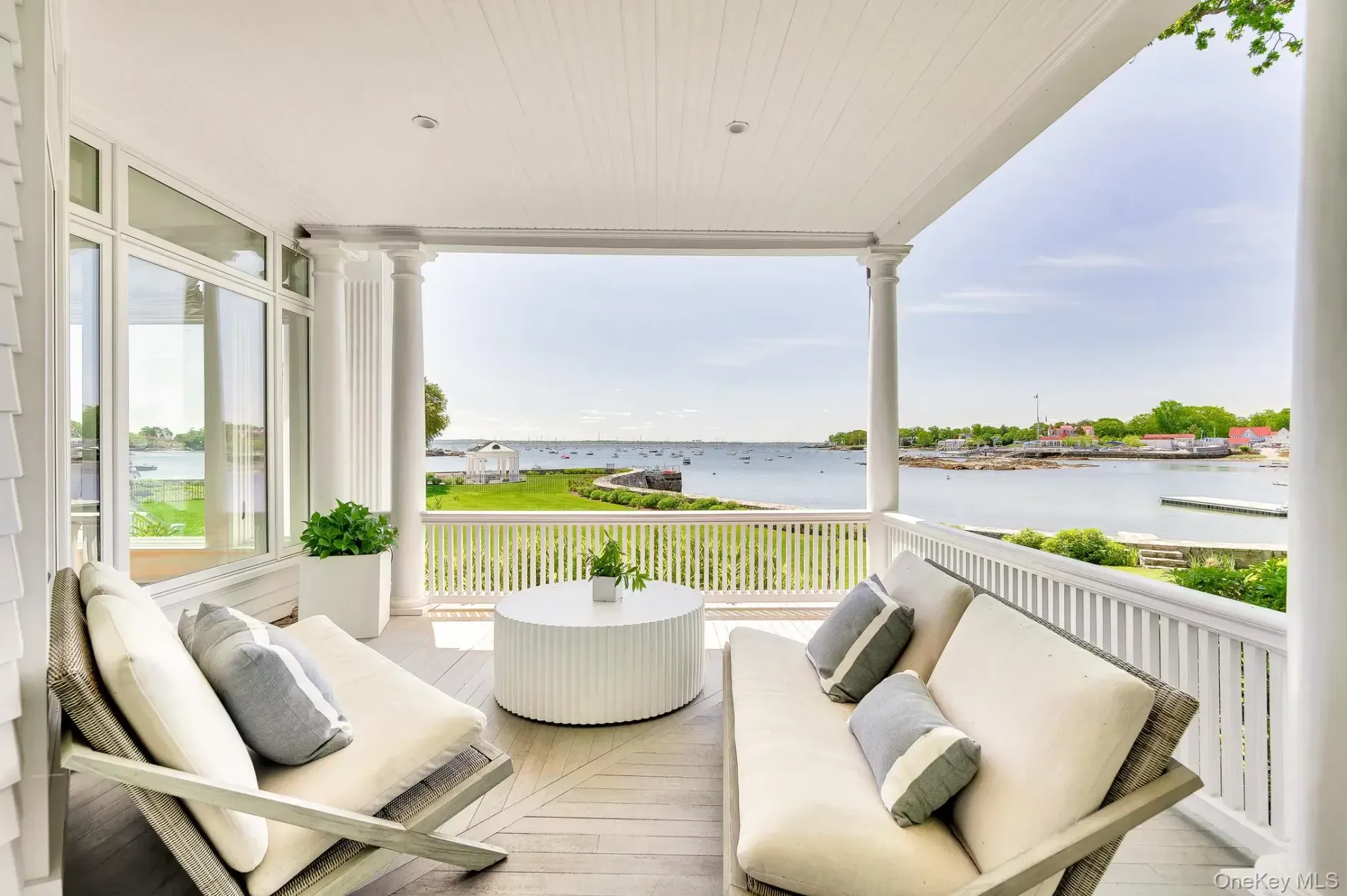 Porch railings and that beaded ceiling—perfect breeze, nothing else needed.