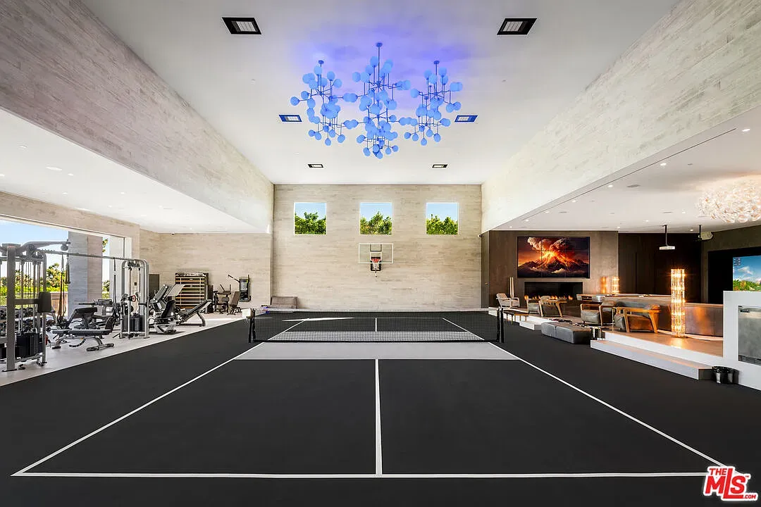 Massive sports room, high ceiling, chandelier with blue LEDs is kinda wild.