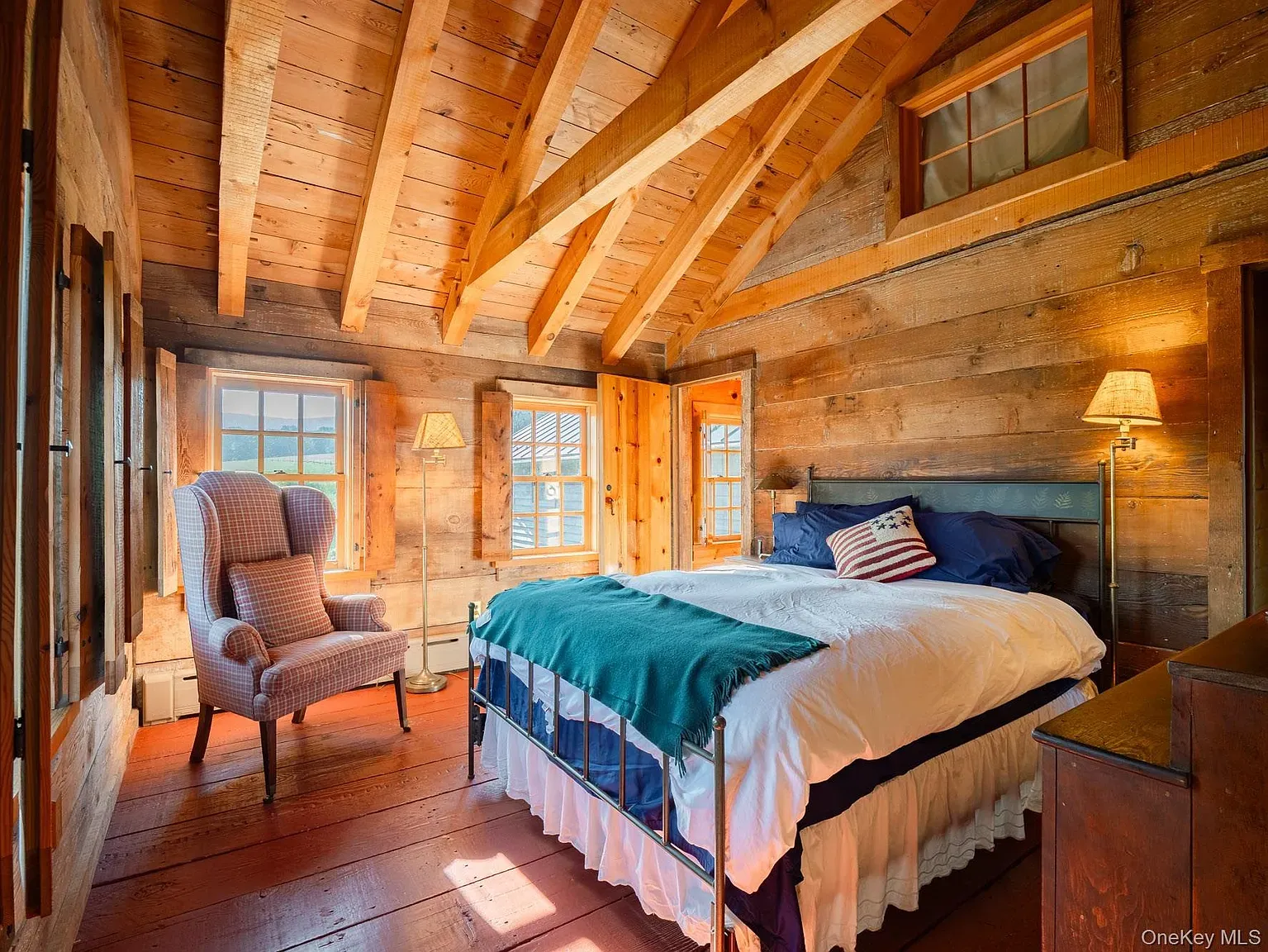 Second bedroom. honey timber, vaulted beams. Sleepy cabin energy turned up.