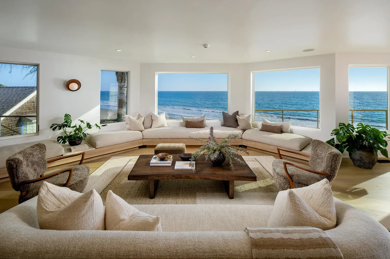 Curved glass wall, soft sandy colors. Living room basically stares at the ocean.