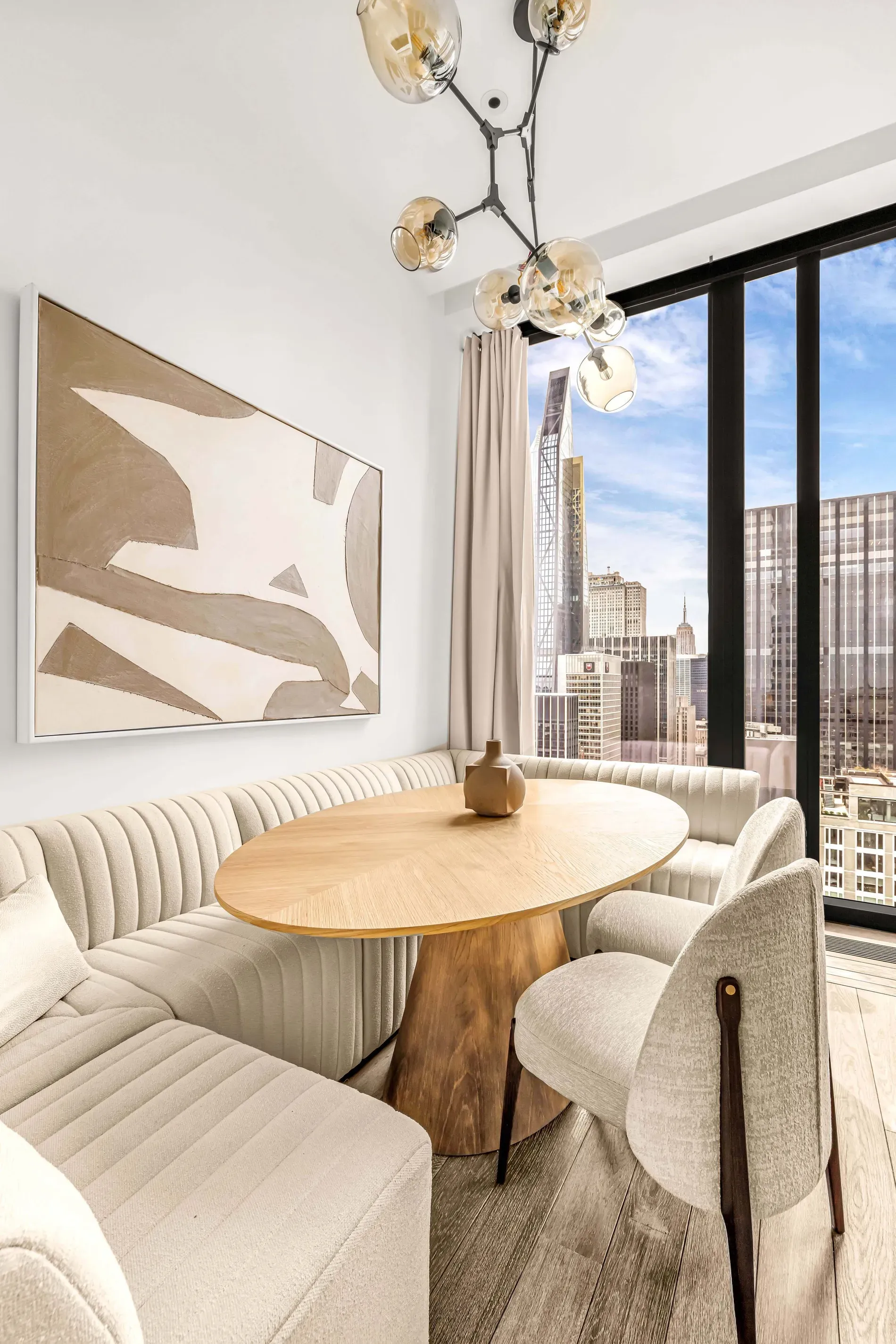 Cute city-view nook — oval table is a win. Breakfast spot secured.