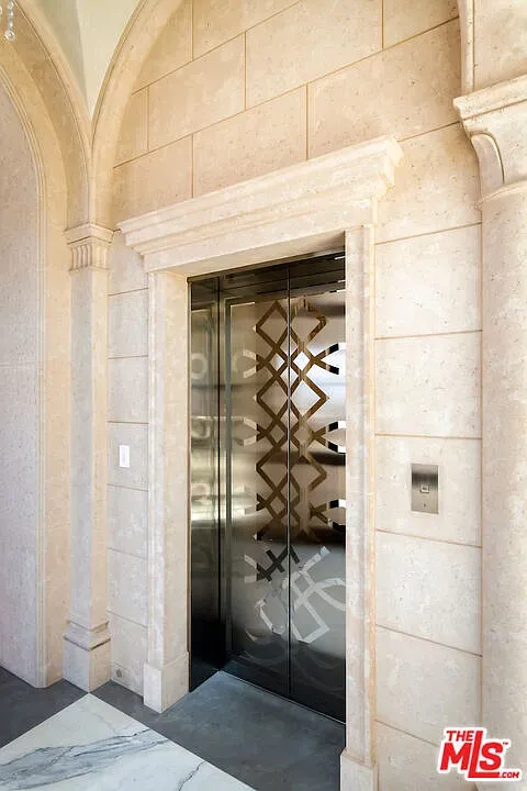 Elevator lobby in arched stone. Why is this nicer than hotels?