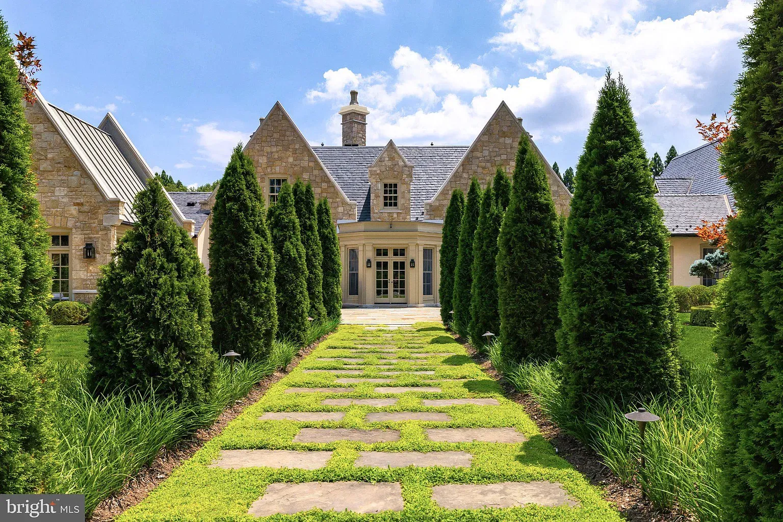 Pathway with big stones and hedge walls. Night lighting probably slaps.