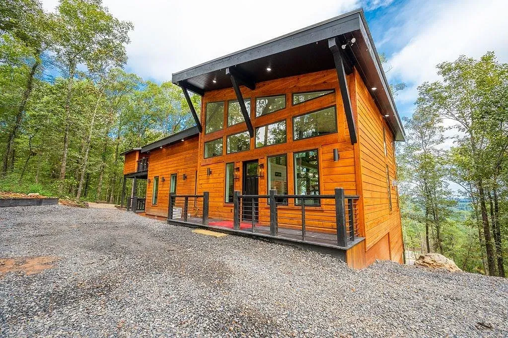 Warm orange wood and black trim. Those floor-to-ceiling windows are doing the most.