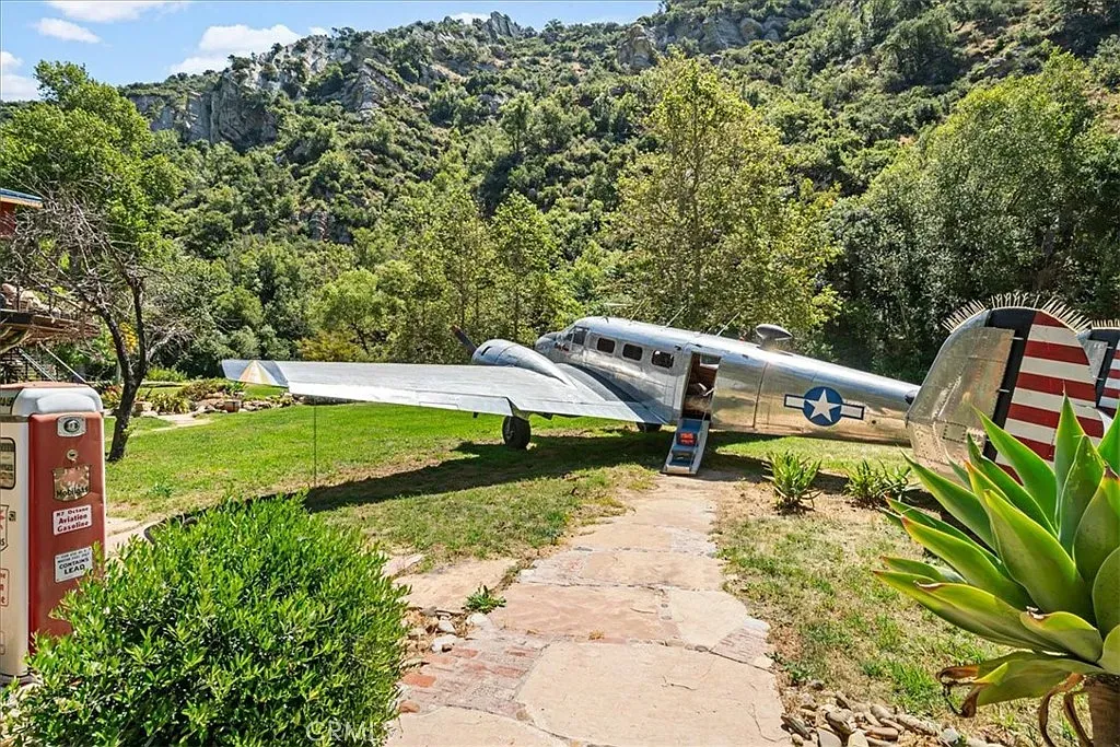 There's... a plane in the yard. Not a metaphor. An actual plane.