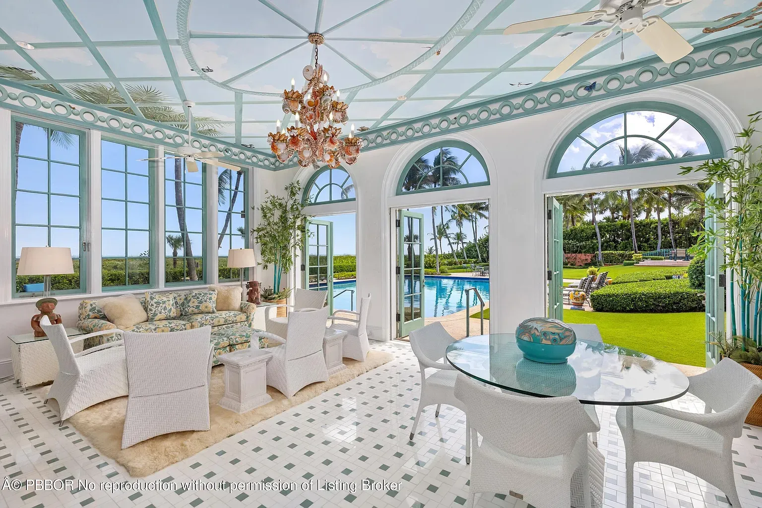 Arched-window sunroom staring at the pool. Pale blue ceiling is cute.