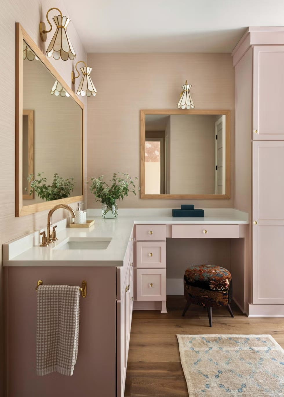 Beige wallpaper and double mirrors make this bathroom feel hotel-nice.