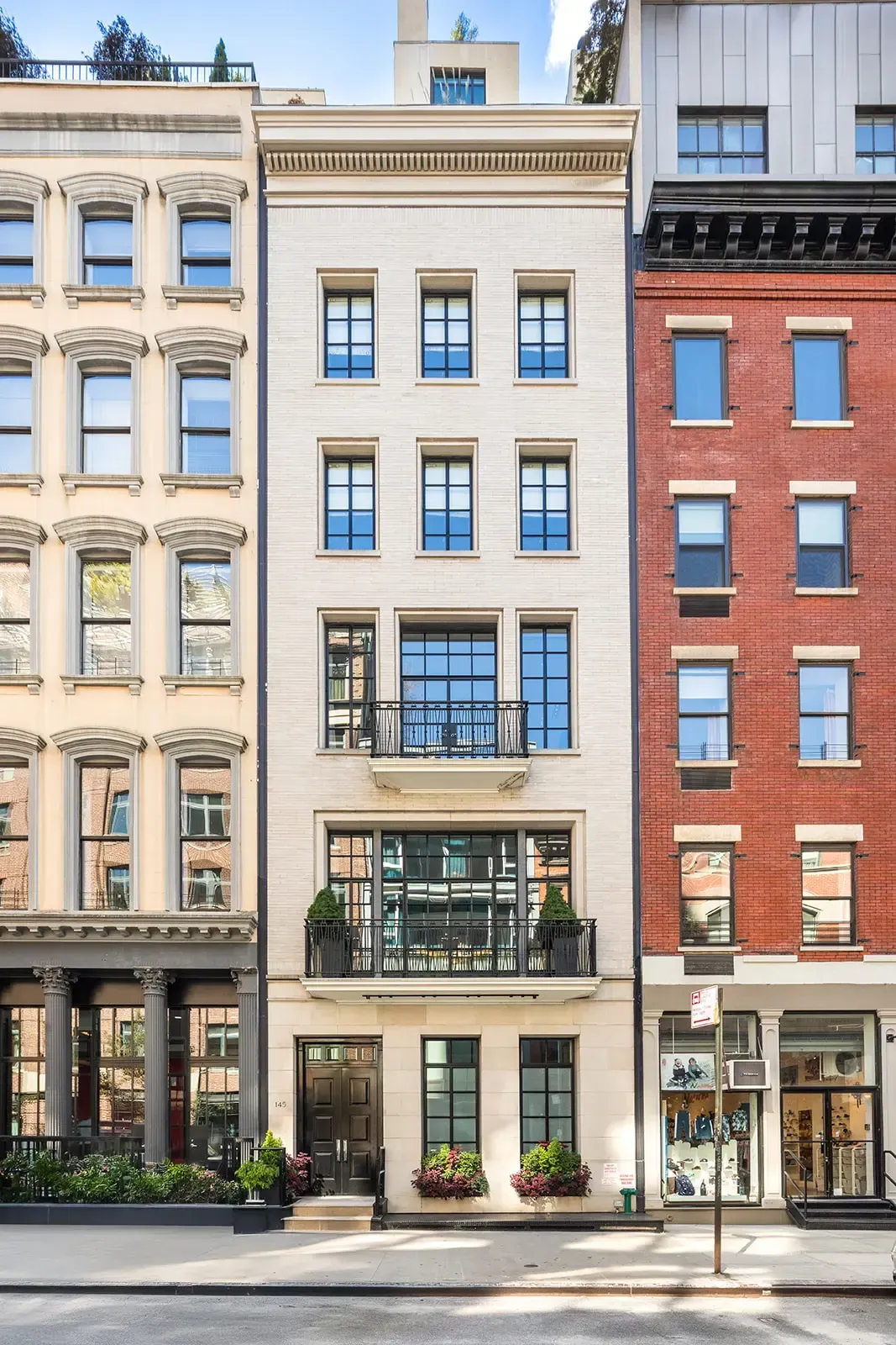 Exterior shot—beige facade, dark frames. Clean lines. Anyone know why that mix?