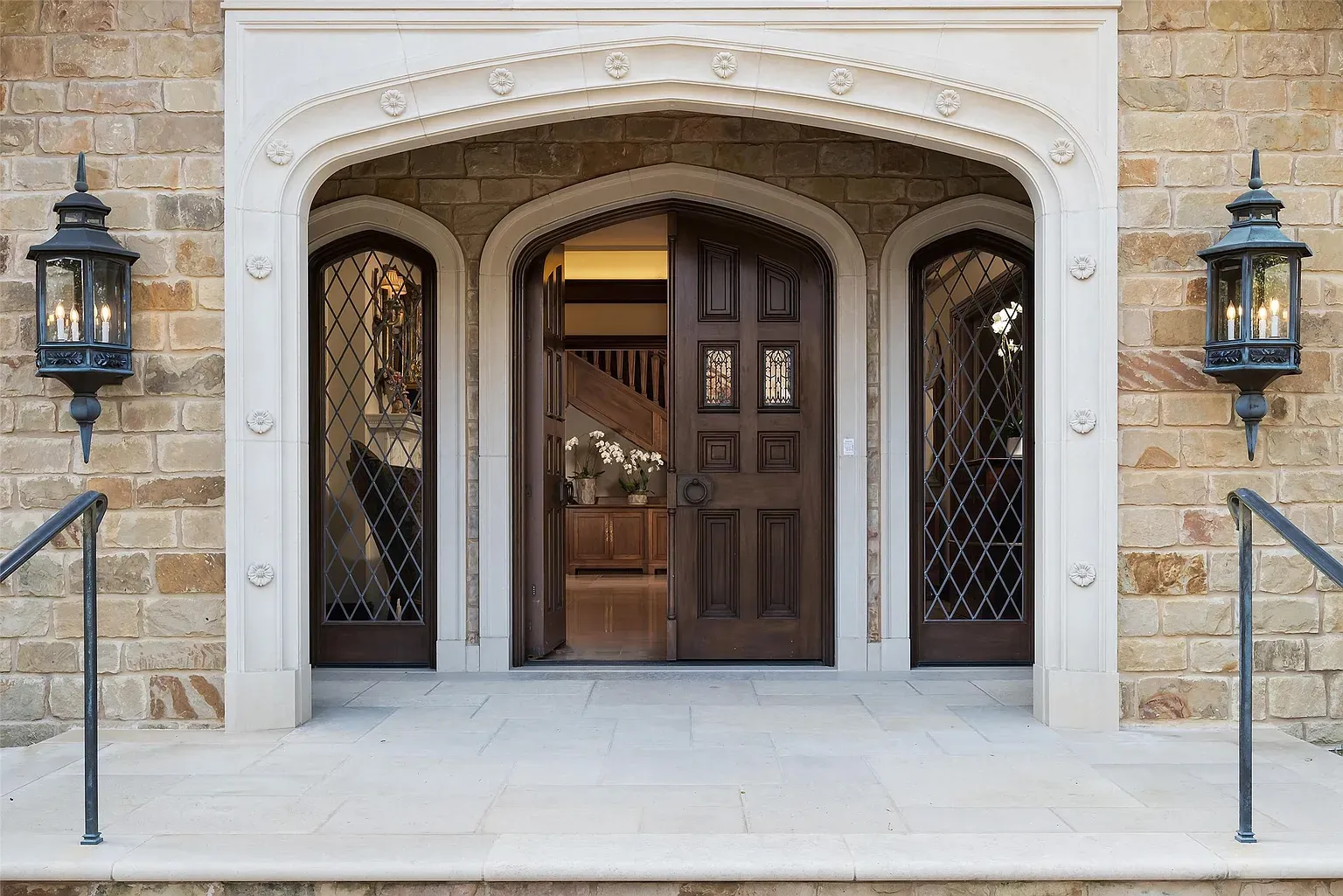 Front arch with carved stone. Heavy, old-world vibe before you even knock.