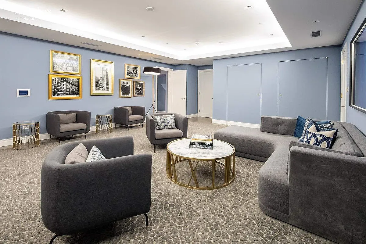 Another lounge, soft blue and gray. Low-profile seating, very hotel-lobby-chill.