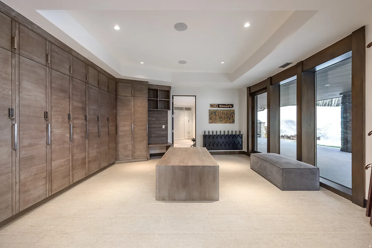 Storage wall for days. Taupe cabinets make the whole room feel calm.