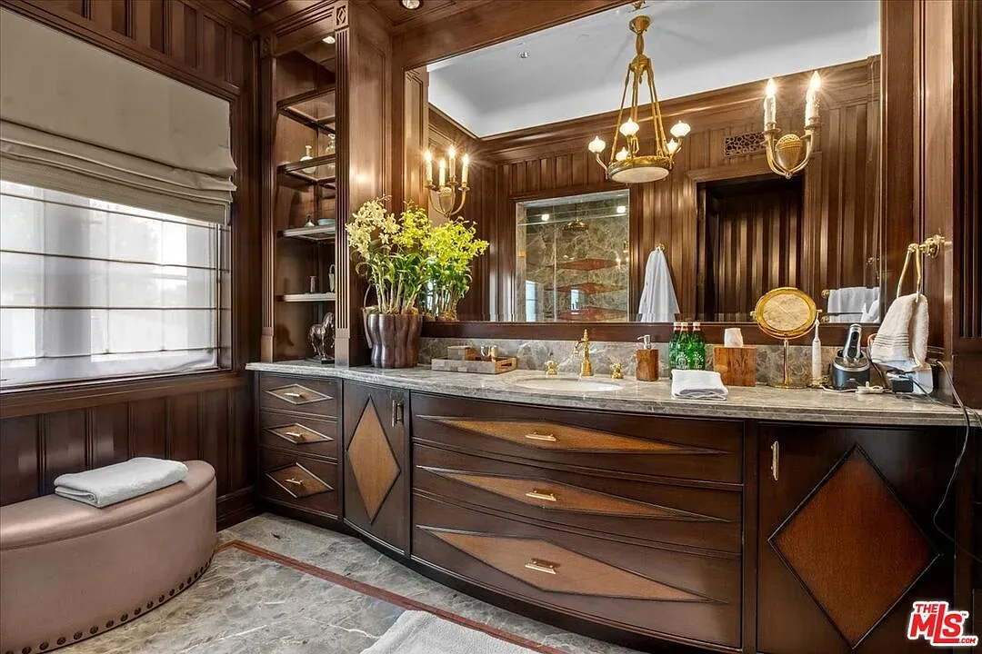 Dark wood slats and a long marble vanity. Hotel-level mood.