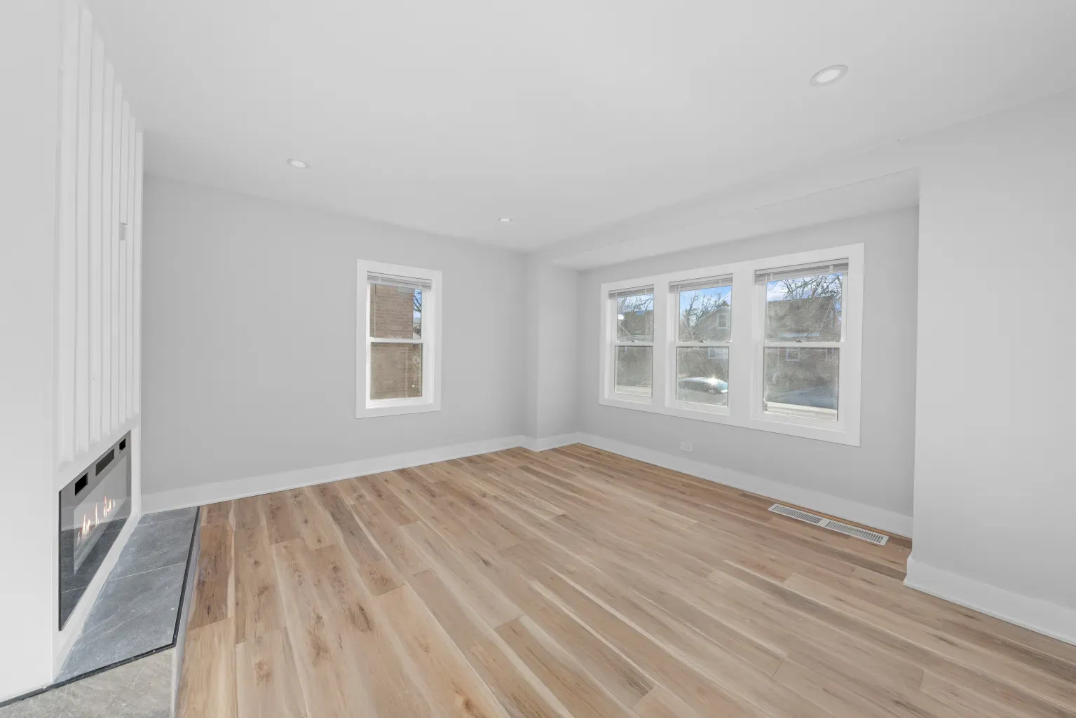 And then the living area—soft grays, pale floors. Nice blank canvas.