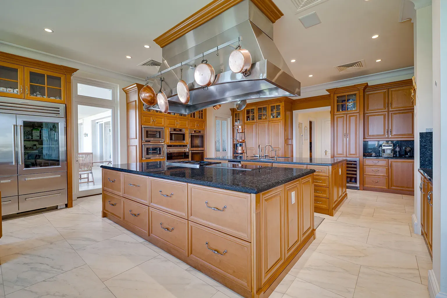 Here's the kitchen—dark granite island, honey cabinets. Classic, but handles feel busy.