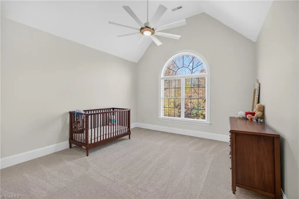 Sweet nursery with a tall ceiling. Easy colors, nap time unlocked.