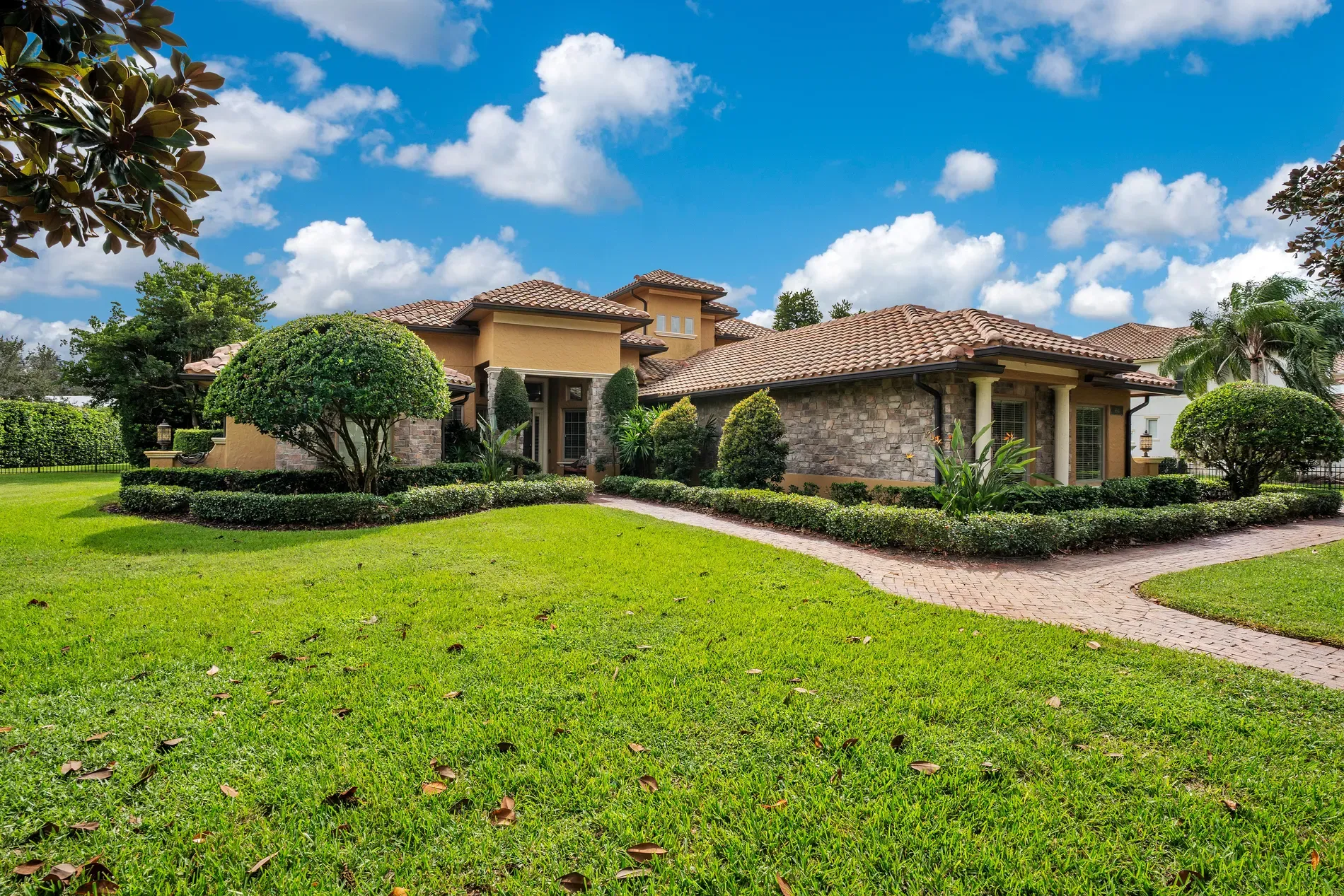 Here's the exterior — Spanish vibes, terracotta roof. Stone details are nice.