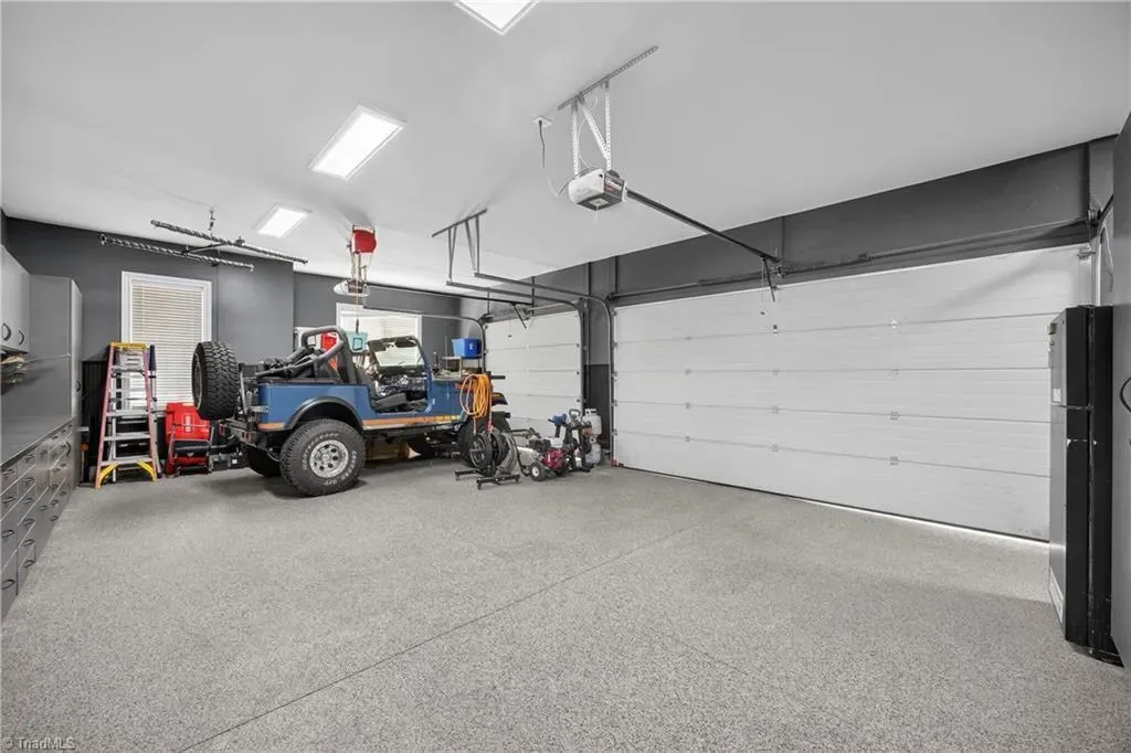 Clean garage with shiny floors. Space for tools and that muddy adventure rig.