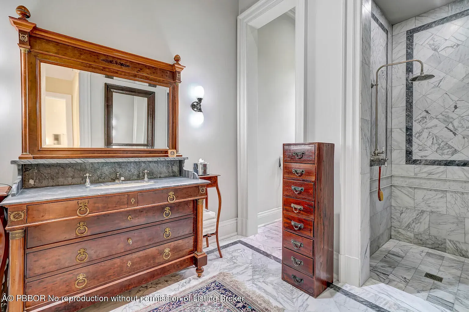 Bathroom flex. carved vanity, black marble top, ornate mirror. Anyone dusting that carving?