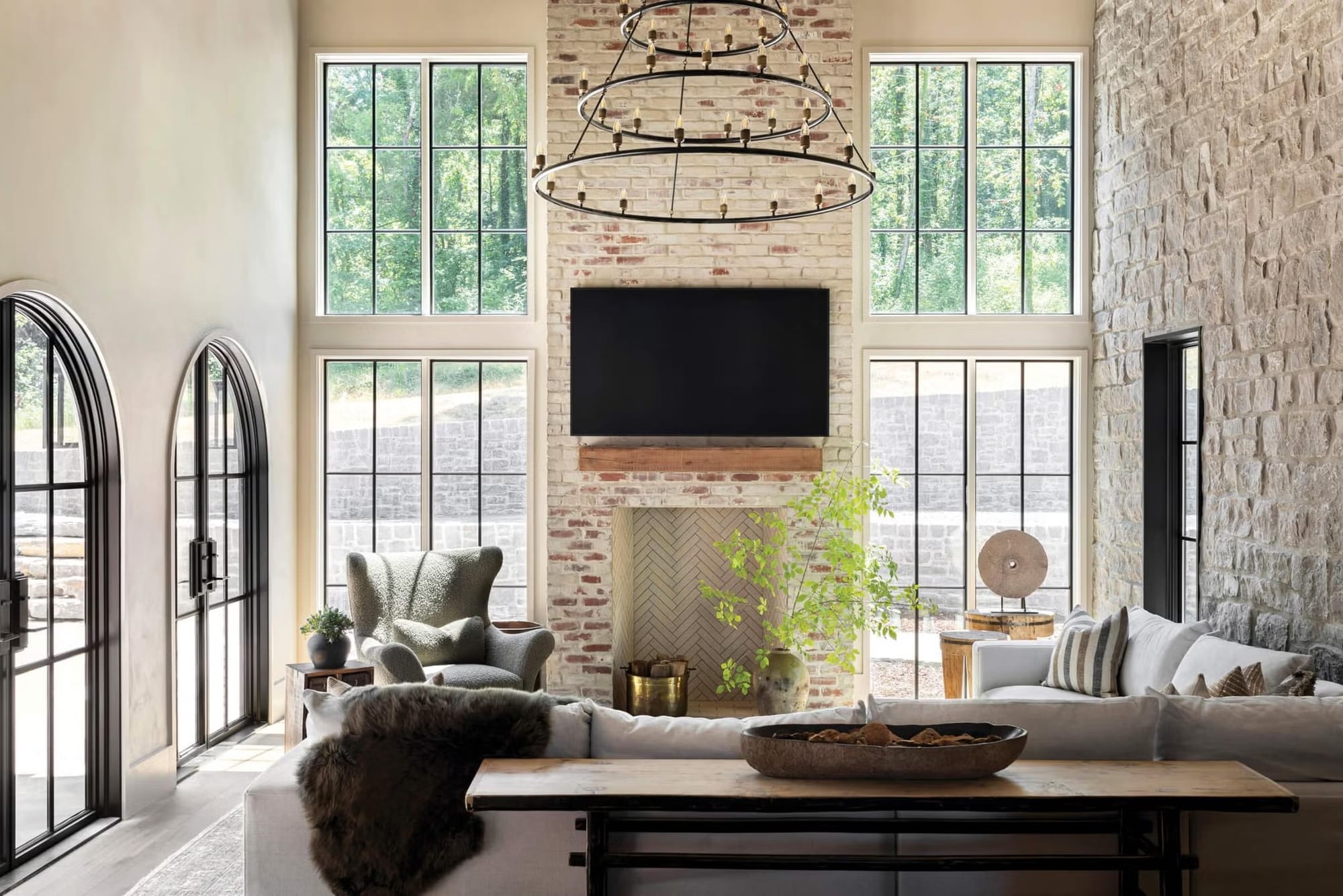 Those floor-to-ceiling windows with the stone wall, bright, warm, and actually livable.