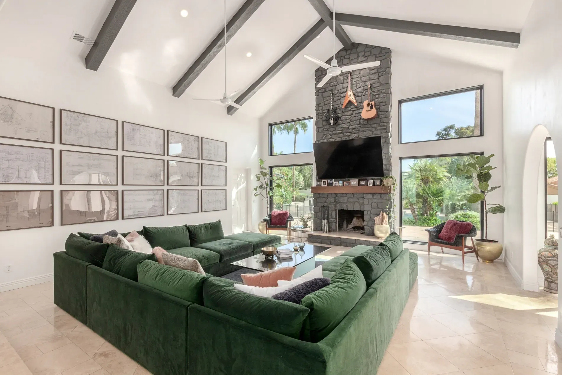 That green sectional owns the room. Plush against sleek finishes. Cozy but polished.