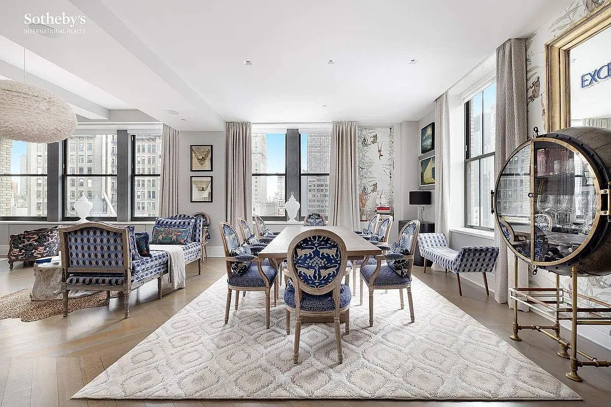 Dining room mixing neutrals with crisp blues. Modern chandelier, classic table. Nice balance.