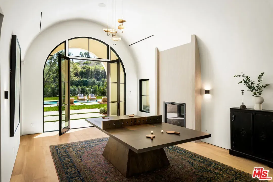 And then this room — arched ceiling, black frames. Cozy cathedral vibes.