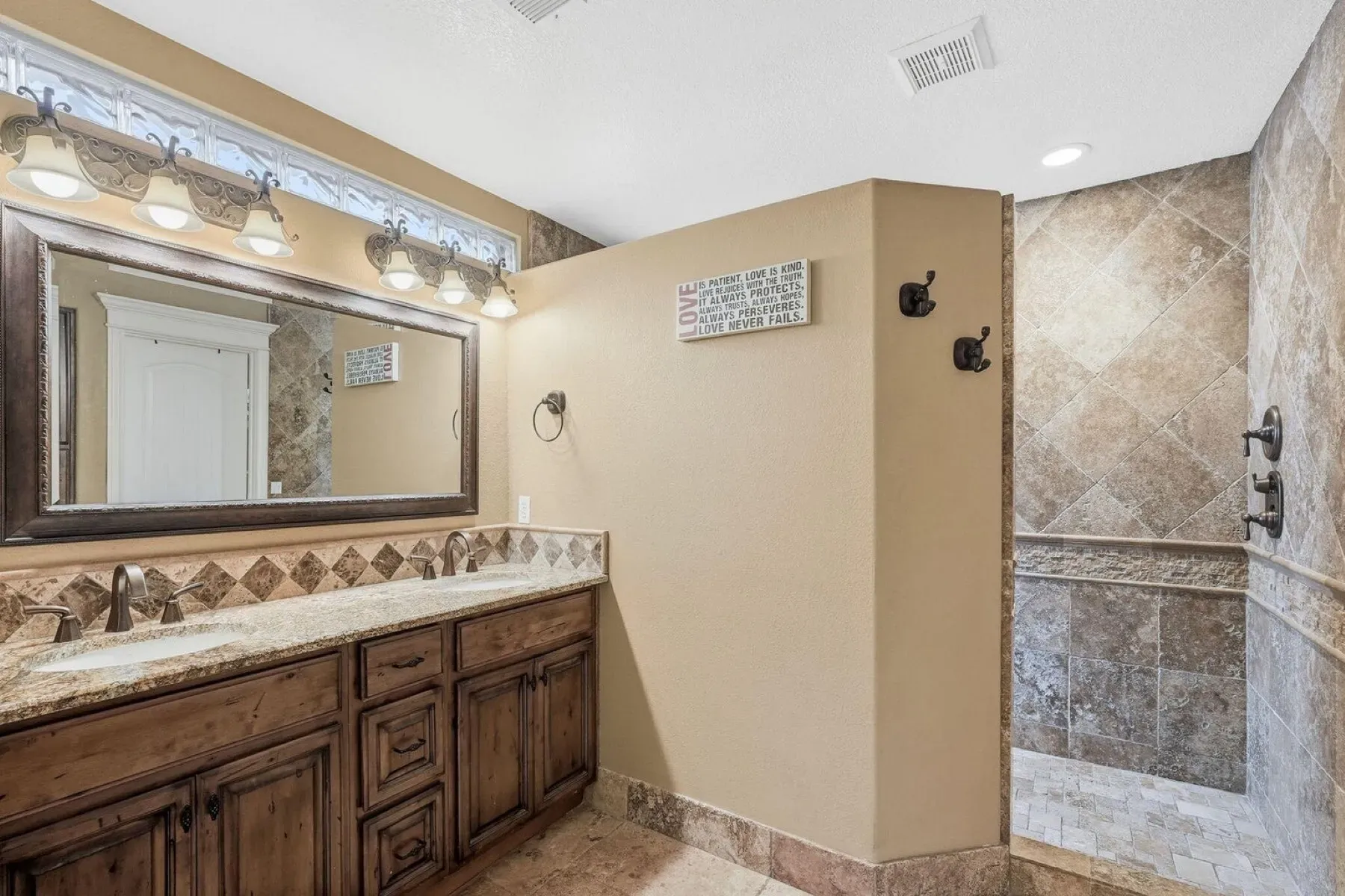 Dark wood double vanity, big mirrors—rustic meets modern without trying too hard.