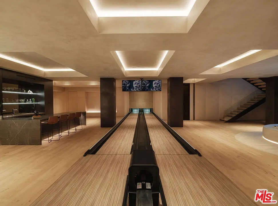 Bowling alley at home—wood lane, moody panels. I mean, cool, maybe too much?