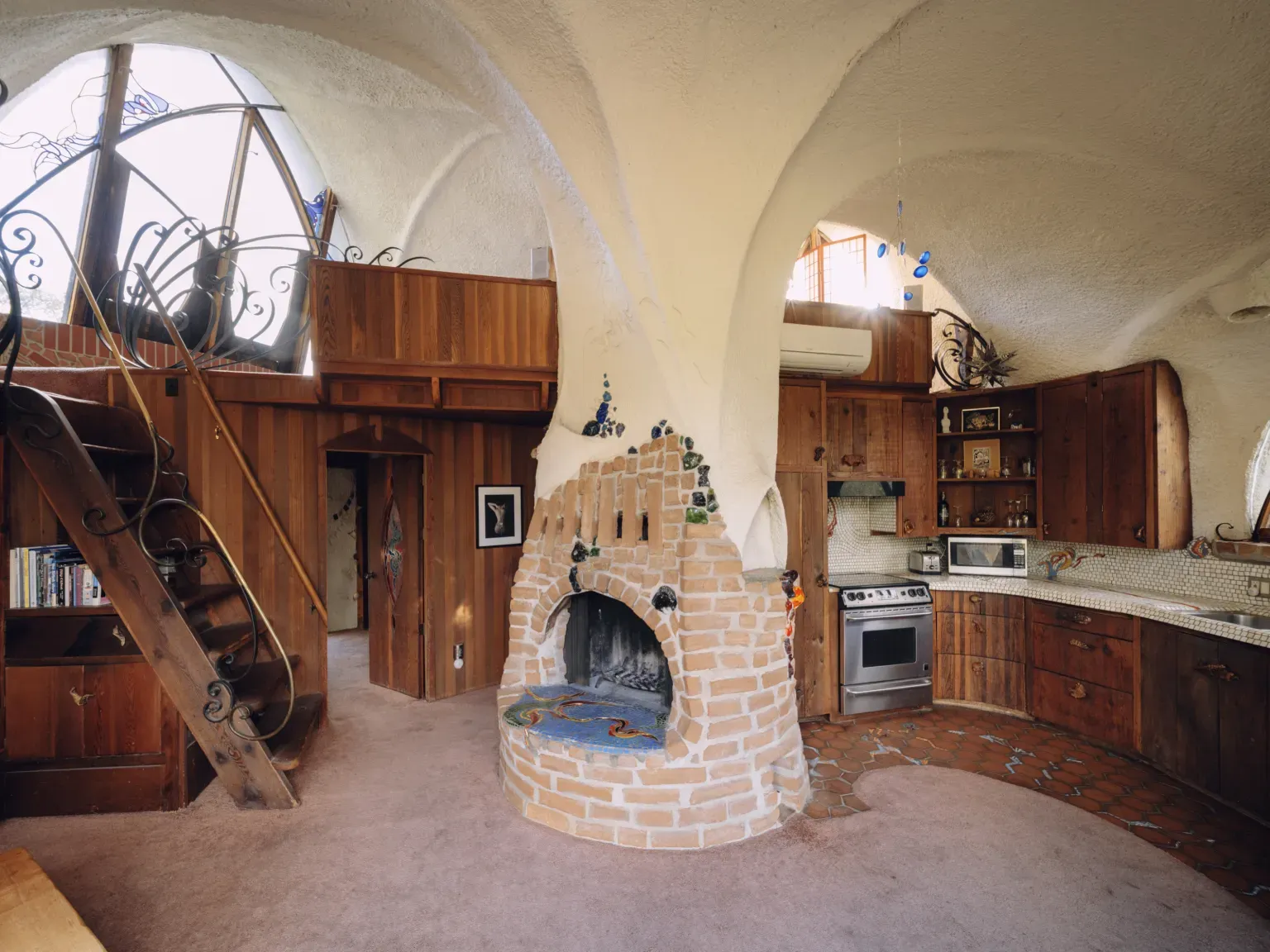 That sculpted fireplace is wild. Textured brick, everything else just softly curves.