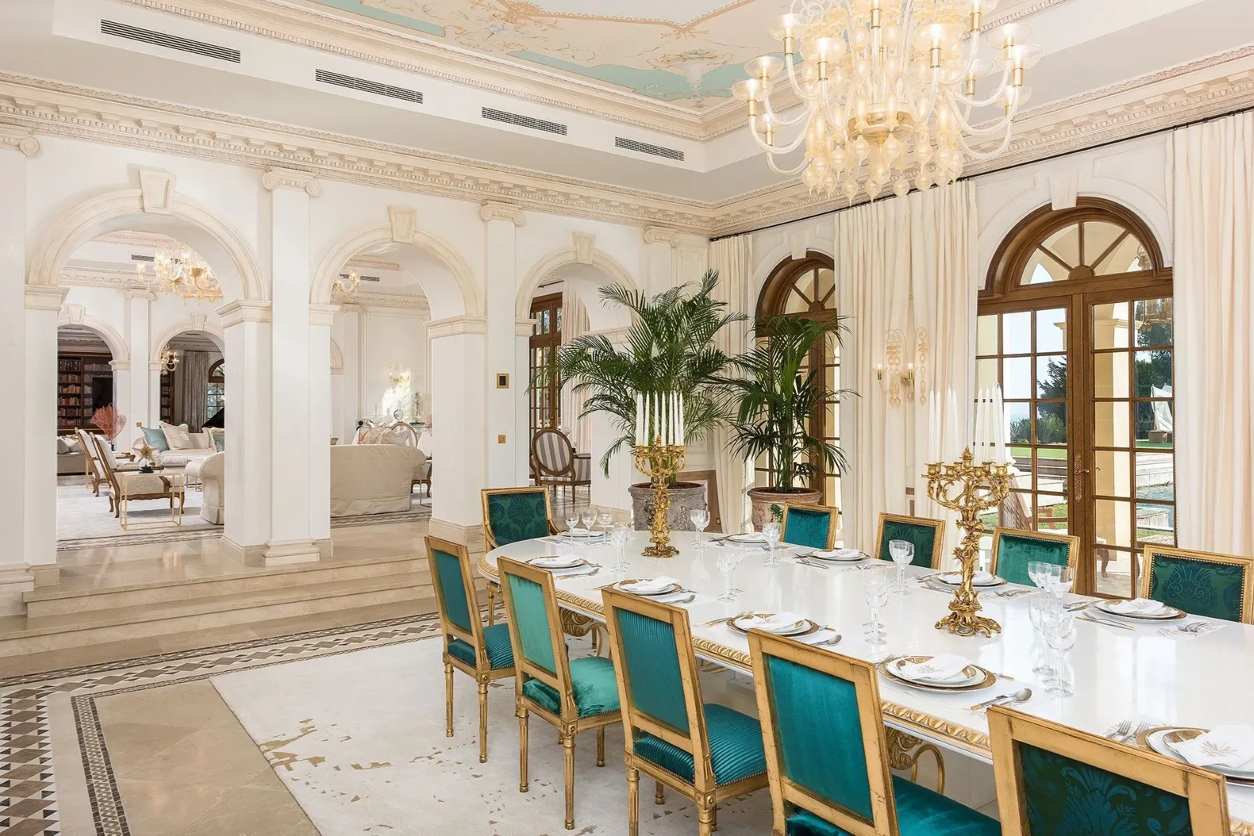 Turquoise thrones around a massive white table. Fancy dinner energy.