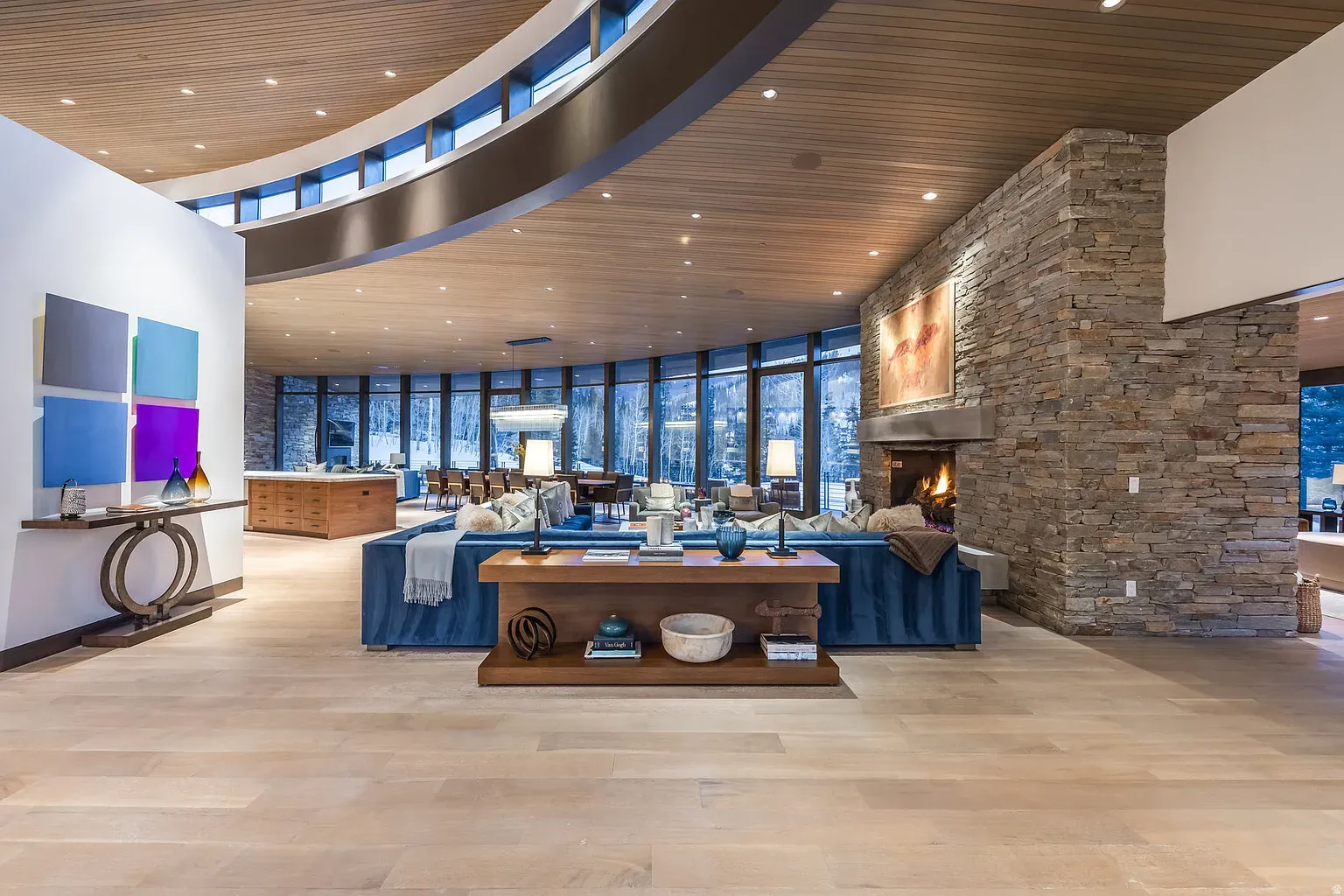 Big open great room, windows everywhere, mountains doing the heavy lifting.