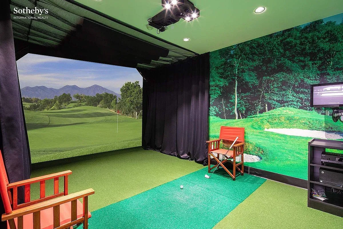 Indoor golf cave in full green. Simulator screen looks legit. Who’s bringing snacks?
