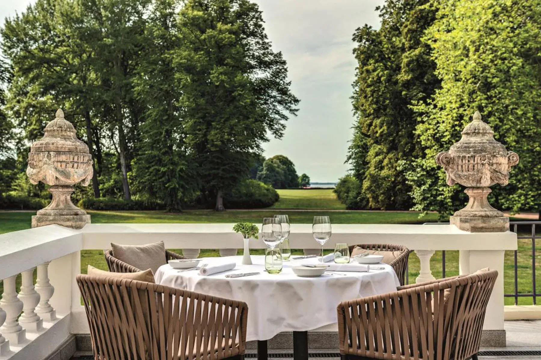 Simple terrace setup—round table, woven chairs, waiting on lemonade.