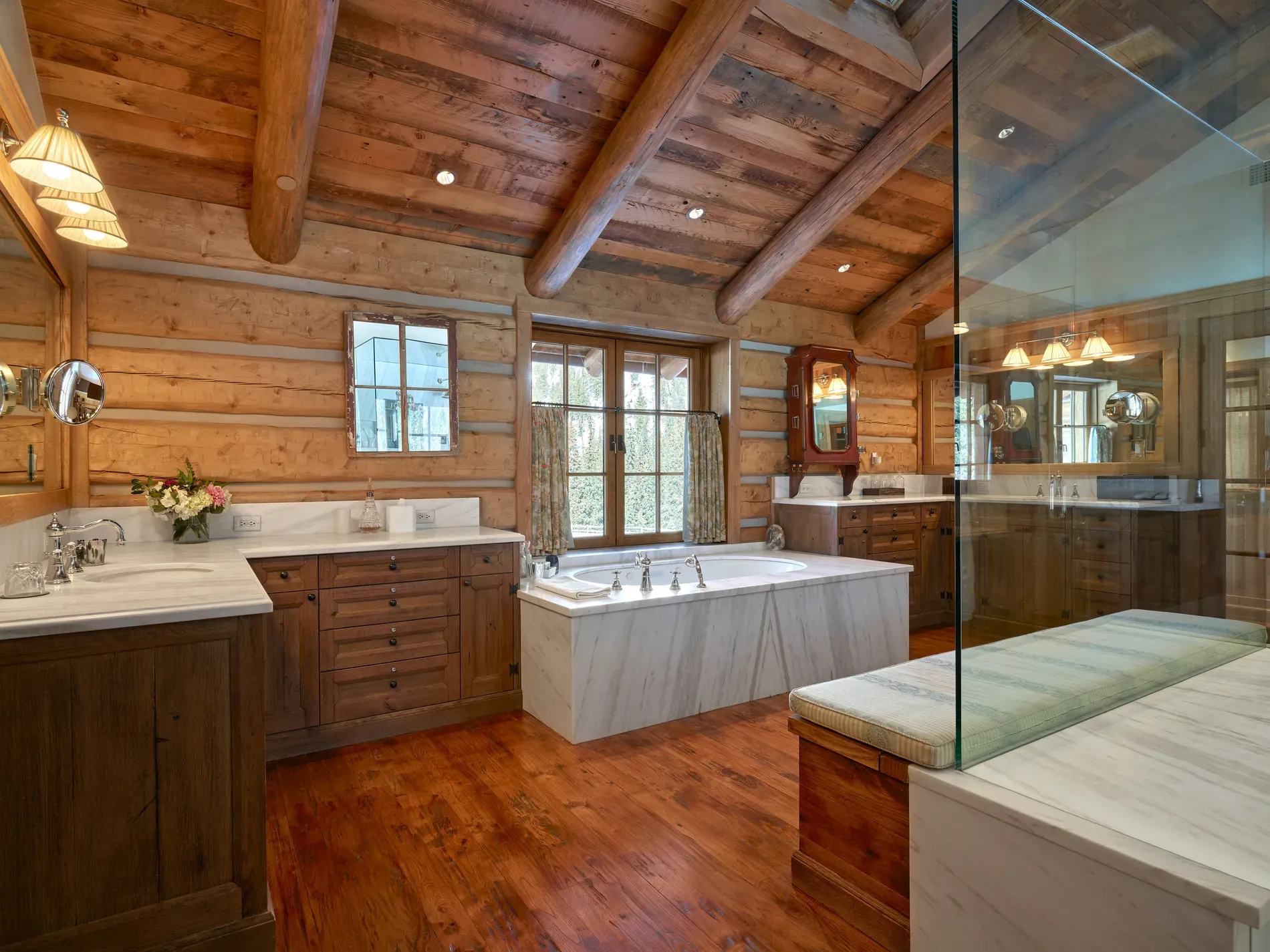Bathroom is full log drama. Rustic spa vibes, beams for days.