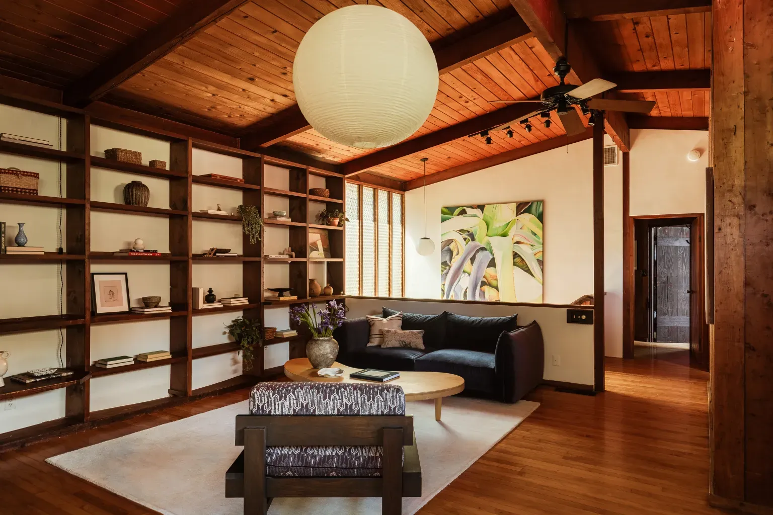 Living room looks super cozy. Beams, wood ceiling, soft light, done.
