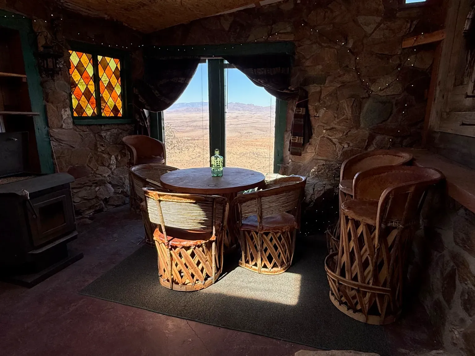 Those chunky stone walls and the big windows straight into the desert.