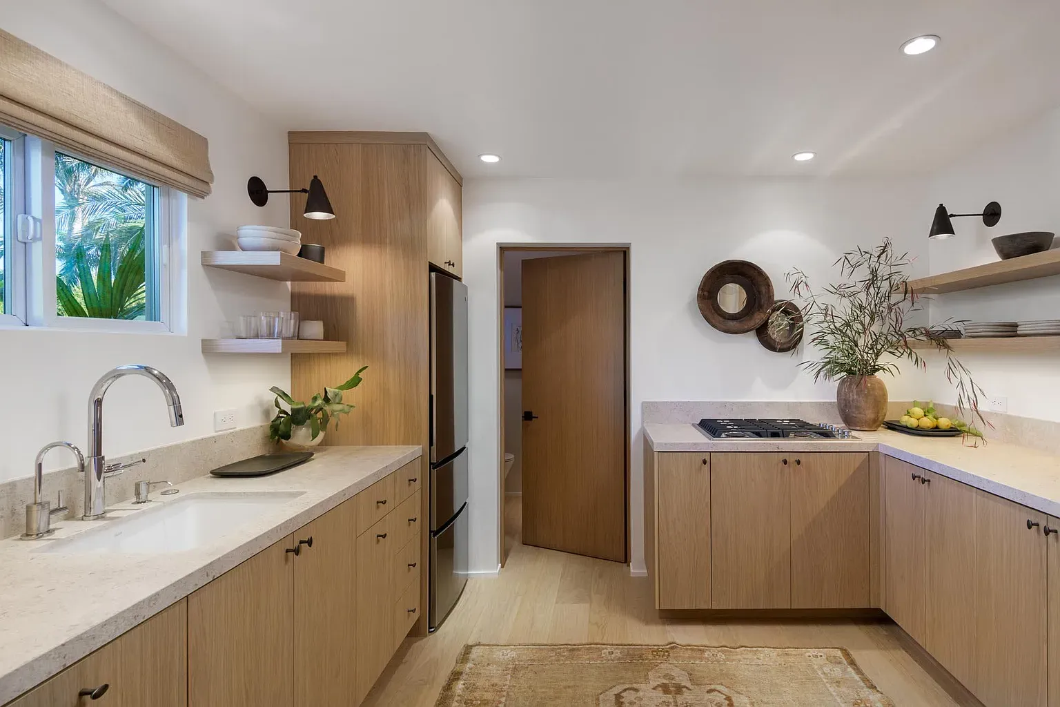 Warm wood kitchen, speckled counters, clean lines. Feels easy to cook and hang.