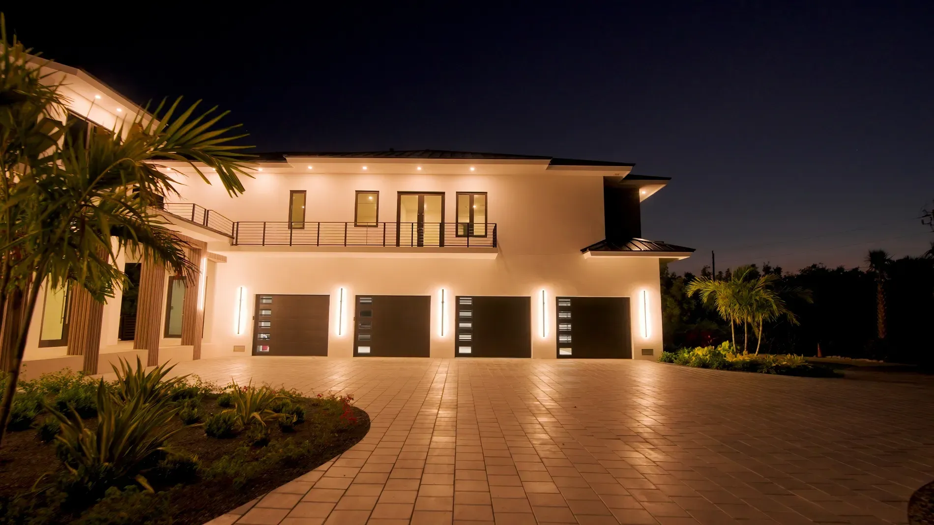 Back outside at twilight—smooth stucco, dark trims, big panes. Feels resort-y.