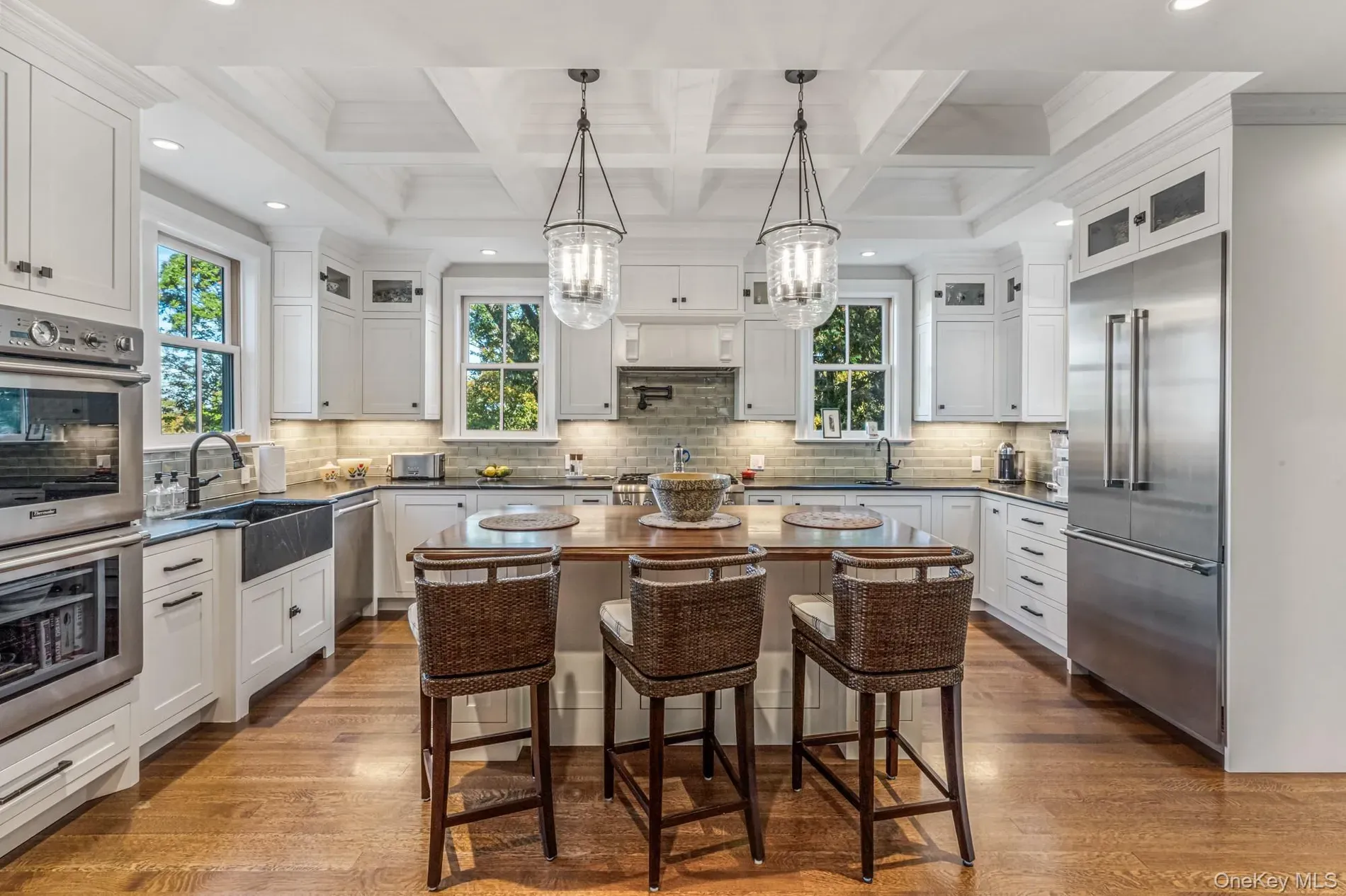 White cabinets with stainless, looks bright. big center island for everything.