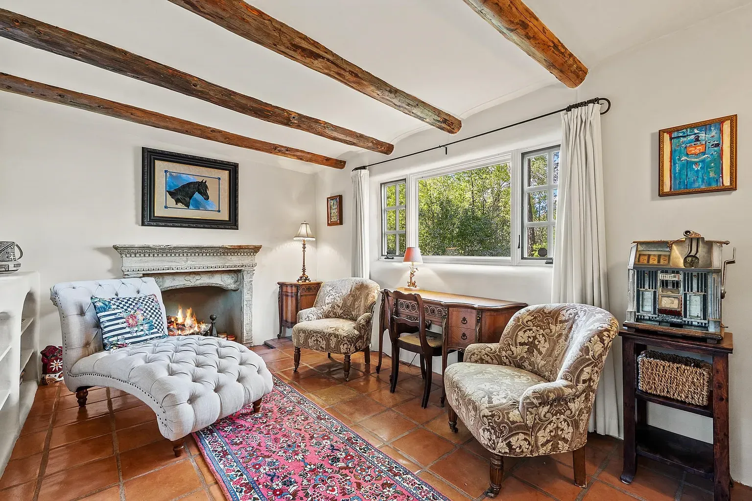 Beams, creamy walls, and a sweet fireplace. Charming finish.