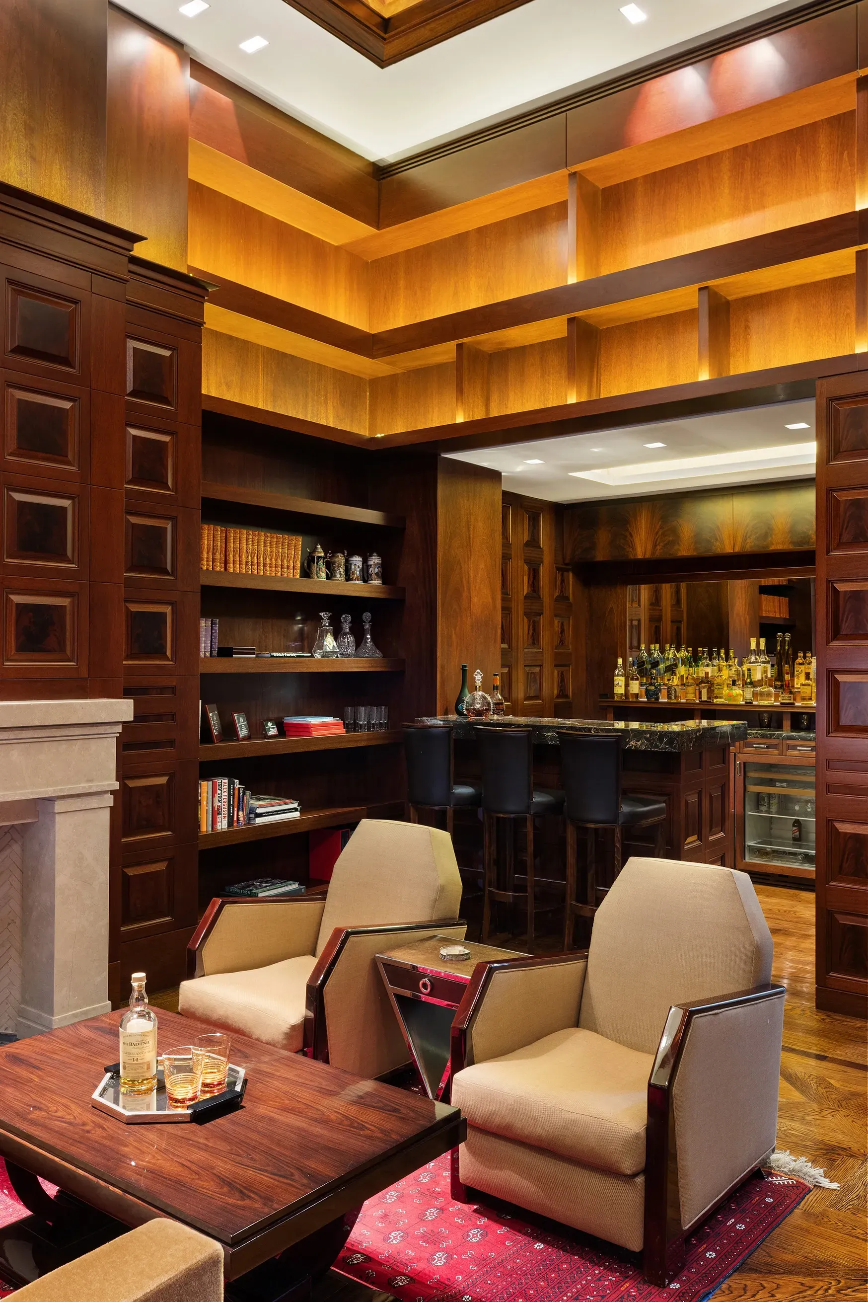 Wood-paneled lounge, coffered ceiling. Warm, clubby, invite-only vibes.