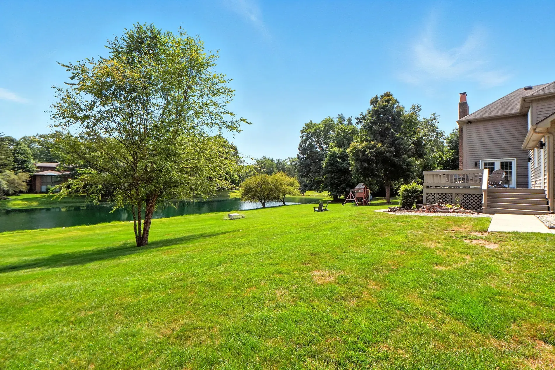 Back outside — big lawn rolling to the water. Low-key dreamy.