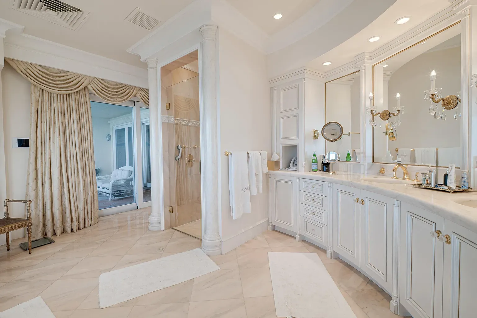 White-on-white bathroom—ornate cabinets, shiny marble, surprisingly not sterile.